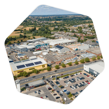 Drone shot of an industrial estate in Chelmsford with car parked in the car parks as well as other cars entering and leaving the estate